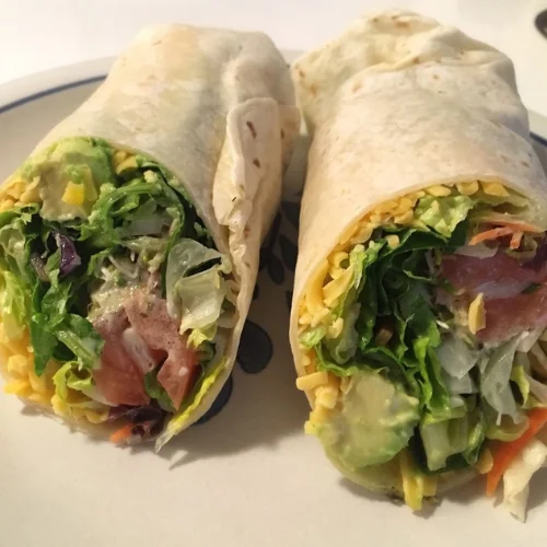 California Roll-Up - Our signature wrap loaded with fresh vegetables, avocado, cheese, and our house dressing — a customer favorite since day one.